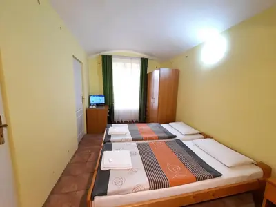 a bedroom with three beds in a room at Pension City Center in Prague