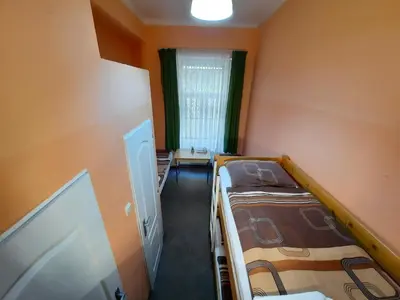 a small room with two bunk beds and a window at Pension City Center in Prague