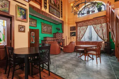 a dining room with green walls and tables and chairs at Penzion Kersko in Hradišťko