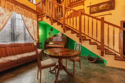 a living room with a table and a staircase at Penzion Kersko in Hradišťko