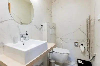 a white bathroom with a sink and a toilet at Penzion Kersko in Hradišťko