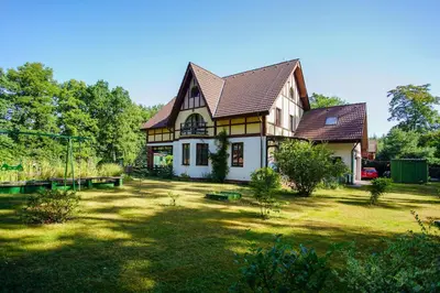 a house with a large yard in front of it at Penzion Kersko in Hradišťko