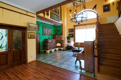 a living room with a staircase and green walls at Penzion Kersko in Hradišťko