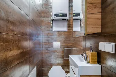 a bathroom with a shower and a washing machine at Charming Apartments Prague by Michal&Friends in Prague