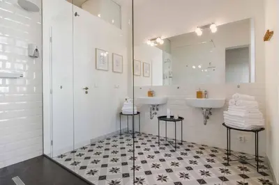 a bathroom with two sinks and a mirror at Charming Apartments Prague by Michal&Friends in Prague