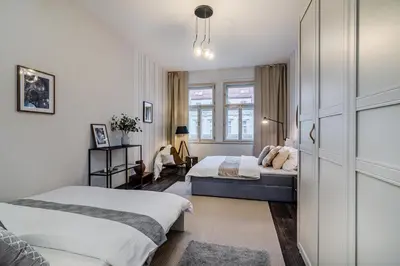 a living room with a leather couch and a tv at Charming Apartments Prague by Michal&Friends in Prague