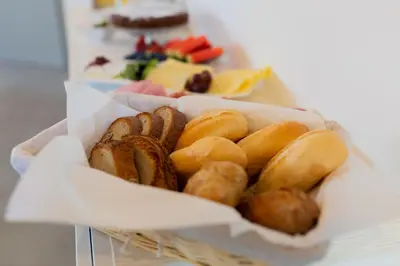 a basket of bread and pastries on a table at Exclusive penzion Viva Residence in Mladá Boleslav