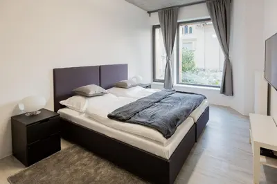 a bedroom with a large bed and a window at Exclusive penzion Viva Residence in Mladá Boleslav