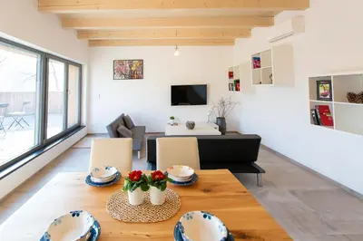 a living room with a table with flowers on it at Exclusive penzion Viva Residence in Mladá Boleslav