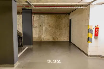 an empty parking garage with a car parked in it at Spacious Terrace Apartment with free private parking in Prague