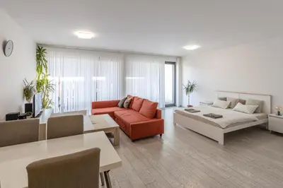 a living room with a couch and a table at Spacious Terrace Apartment with free private parking in Prague