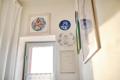 a hallway with plates on the wall and a doorway at Rusty's Cottage in Sedlčany