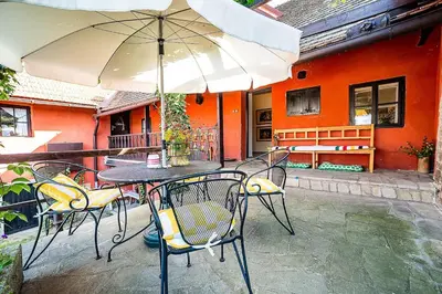 a table and chairs with an umbrella on a patio at Rusty's Cottage in Sedlčany