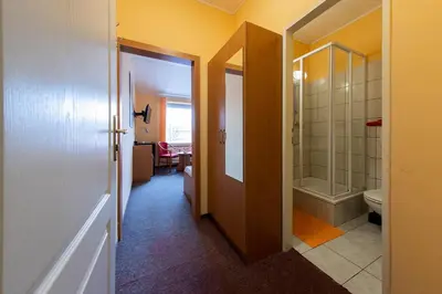 a bathroom with a walk in shower and a toilet at Penzion Školička in Prague