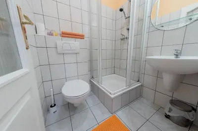 a small bathroom with a toilet and a sink at Penzion Školička in Prague