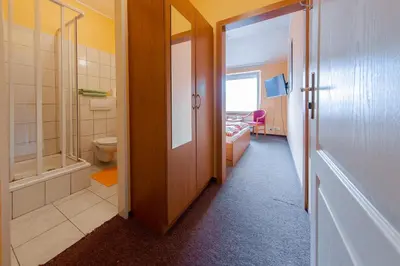 a bathroom with a walk in shower and a toilet at Penzion Školička in Prague