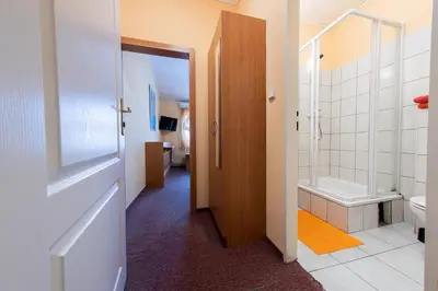 a bathroom with a walk in shower and a toilet at Penzion Školička in Prague