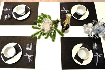 a table with black and white plates and christmas decorations at Sublime Studio with Big Terrace in Prague