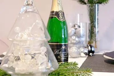 a green bottle of wine sitting on top of a table at Sublime Studio with Big Terrace in Prague