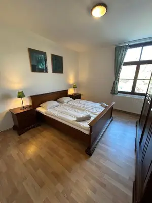 a bedroom with a large bed and a window at Penzion Maják in Dublovice