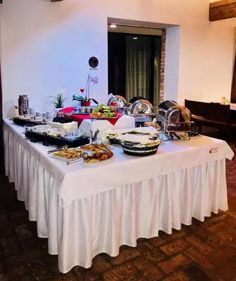 a buffet table with food on a white table cloth at Sand Martin in Mladá Boleslav