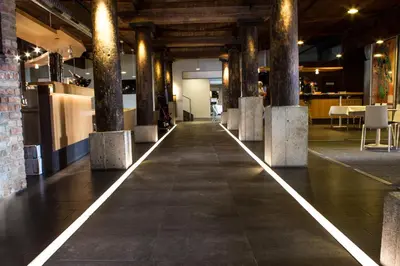 a hallway with columns and tables in a building at Sand Martin in Mladá Boleslav