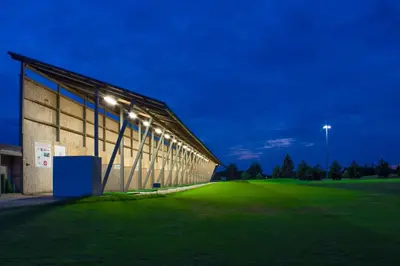 a building with lights on the side at night at Sand Martin in Mladá Boleslav
