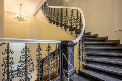 a stairway with a wrought iron railing and a staircase at Modern cozy apartment in central Prague in Prague