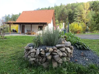 a rock garden in front of a house at Rekreační dům v Brdech Pod Svatou Annou in Ohrazenice