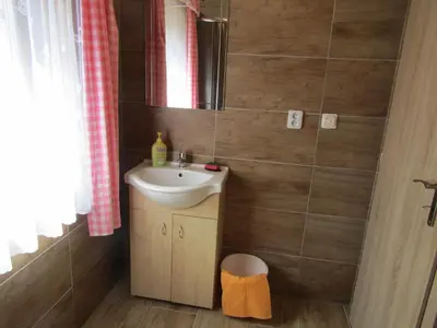 a small bathroom with a sink and a mirror at Rekreační dům v Brdech Pod Svatou Annou in Ohrazenice