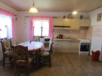 a kitchen with a table and chairs and a kitchen with a table and a kitchen at Rekreační dům v Brdech Pod Svatou Annou in Ohrazenice
