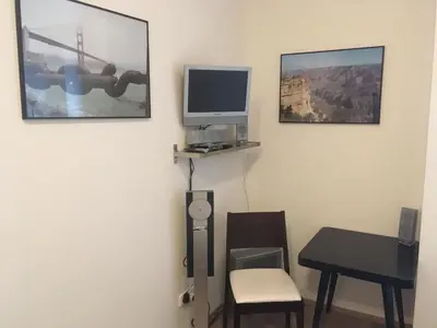 a room with a desk and a computer monitor on a wall at BAILANDO Studio in Neratovice