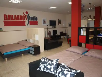 a room with two beds and a living room at BAILANDO Studio in Neratovice