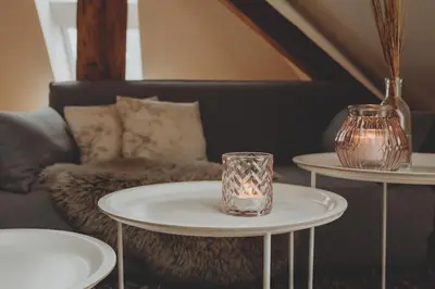 a glass on two tables next to a couch at Penzion Nový Rybník in Obořiště