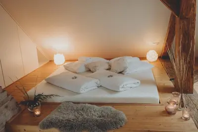 a bed with white pillows on it in a room at Penzion Nový Rybník in Obořiště