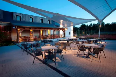 a group of tables and chairs on a patio at Penzion Nový Rybník in Obořiště