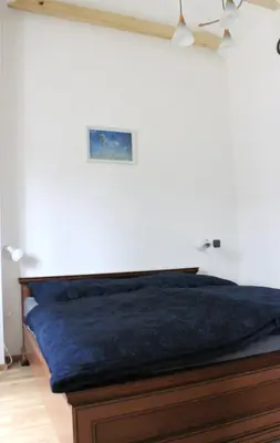 a bedroom with a bed with a blue blanket at Domek Praha - Zbraslav, u zámku in Prague
