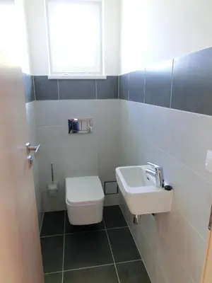 a bathroom with a toilet and a sink at Black Bridge Hotel Apartment in Prague