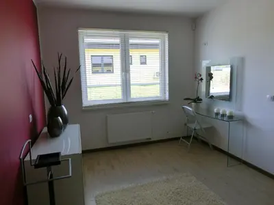 a living room with a desk and two windows at Black Bridge Hotel Apartment in Prague