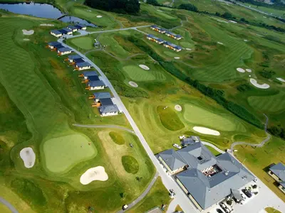 an overhead view of a golf course with a building at Black Bridge Hotel Apartment in Prague