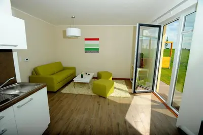 a living room with a green couch and a table at Black Bridge Hotel Apartment in Prague