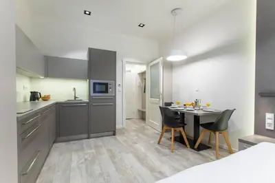 a kitchen and dining room with a table and chairs at Lampi Aparthotel Prague in Prague