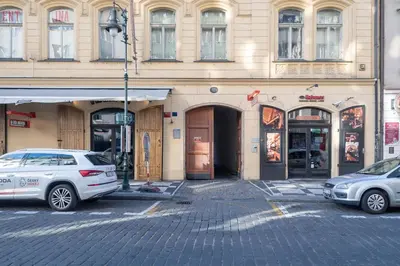 a building with two cars parked in front of it at Charming Old Town Retreat in Prague