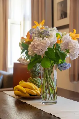 a vase with flowers and bananas on a table at Charming Old Town Retreat in Prague