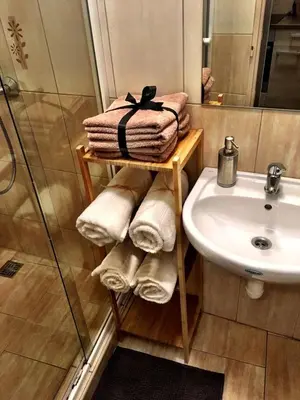 a bathroom with a sink and a shower and towels at Charming Old Town Retreat in Prague