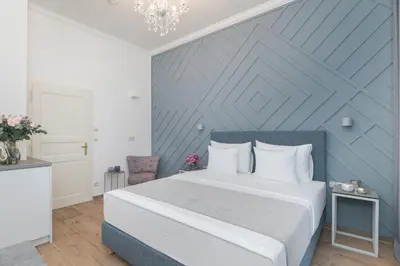 a bedroom with a bed and a blue wall at Eight Secrets Boutique Residence by Dwellfort in Prague