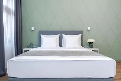 a bedroom with a large bed with white pillows at Eight Secrets Boutique Residence by Dwellfort in Prague