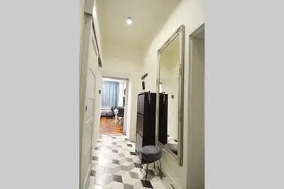 a hallway with a room with a mirror and a stool at BRANDLY NEW APARTMENT ANDĚL in Prague
