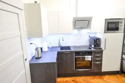 a small kitchen with a sink and a microwave at BRANDLY NEW APARTMENT ANDĚL in Prague