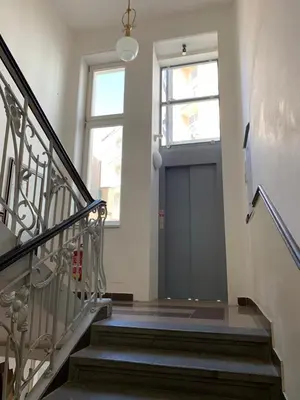 a staircase with a large door and a window at VIP city CENTER apartment Prague in Prague